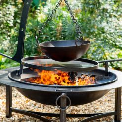 Saturn fire pit with Swing Arm BBQ Rack and Hanging Arm with bowl lit on gravel - Lifestyle - Firepits UK - LoRes600x600 341