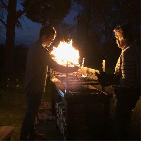 Asado BBQ with Log Store Lit Lifestyle at Night - Firepits UK - BBQ - Lo Res