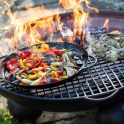 Ball Stand Fire Pit Lit with half Moon BBQ Rack and Skillet Pan with Peppers and Chicken Lifestyle - Firepits UK - WEB - Lo Res