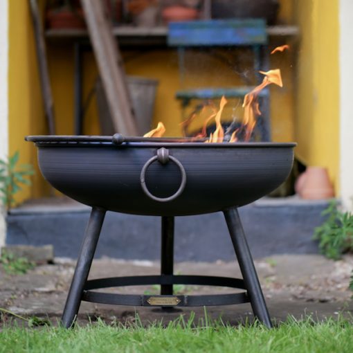 Classic Fire Pit Lit in front of Tool Shed with Half Moon BBQ Rack Lifestyle - Firepits UK - WEB - Lo Res