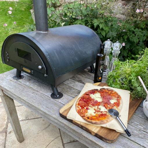 Table Top Pizza Oven Fire Pit with cooked pizza Lifestyle - Firepits UK - WEB - Lo Res1