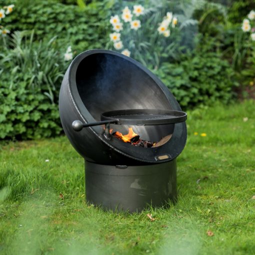 Tilted Sphere Fire Pit Lit with Swing Arm BBQ Rack Lifestyle - Firepits UK - WEB - Lo Res
