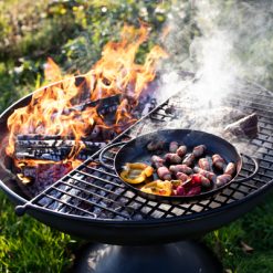 Wine Glass Fire Pit Lit with Half Moon BBQ Rack and Skillet Pan with Peppers and Pigs in Blankets Lifestyle - Firepits UK - WEB - Lo Res