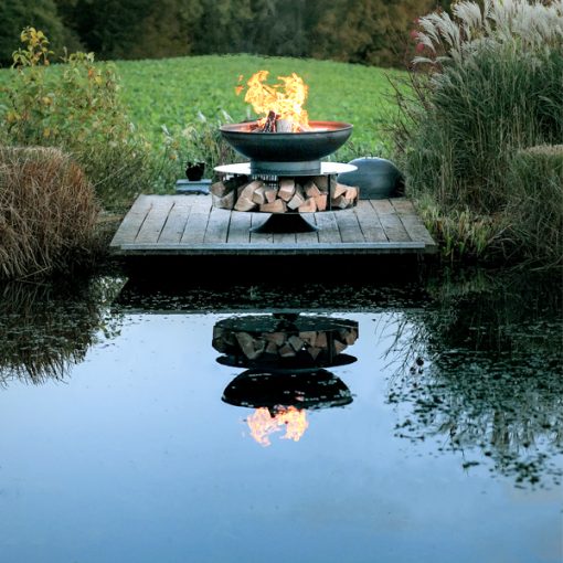 Ring of Logs 90 with Swing Arm BBQ Rack Fire Pit - Lifestyle by water - Firepits UK - WEB - Lo Res