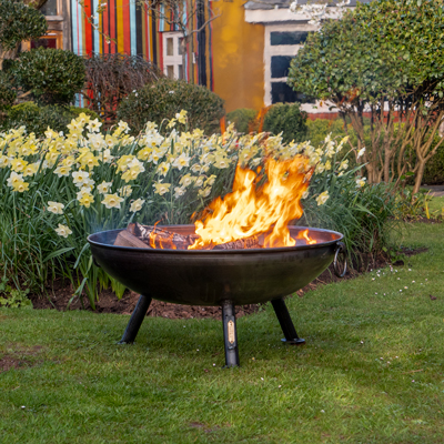 Celeste Fire Pit Lifestyle in front of Daffodils - Firepits UK - Lo Res