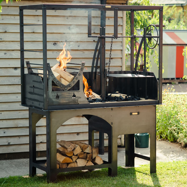 Portico Grill outdoor fire cage barbecue with adjustable wheel made by Firepits UK used by Marcus Wareing