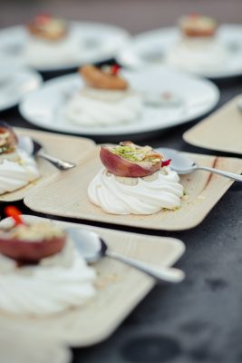 Peaches served with cream in a Pavlova dome