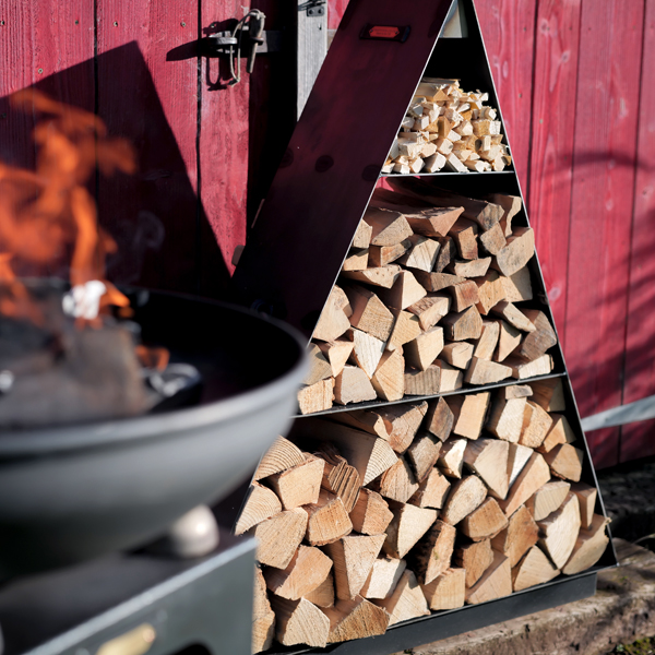 wood stored in a triangle by a fire pit