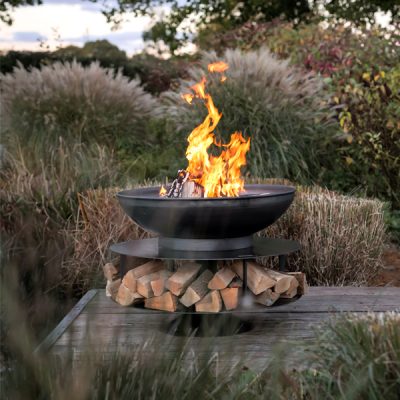 fire pit lit by lakeside