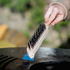 Wire Brush in use on Plancha Fire Pit - Lifestyle - Firepits UK - PP23 - LoRes474