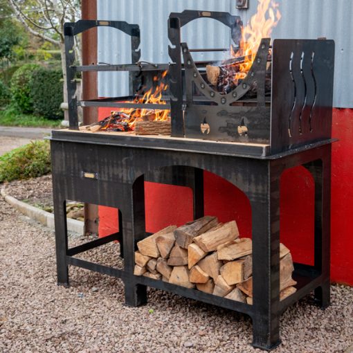 Asado BBQ with Log Store- Lit - Side on - Firepits UK - LoRes675600x600